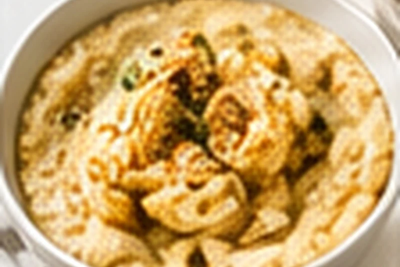 A bowl of creamy oat porridge topped with sliced banana and a small swirl of almond butter.