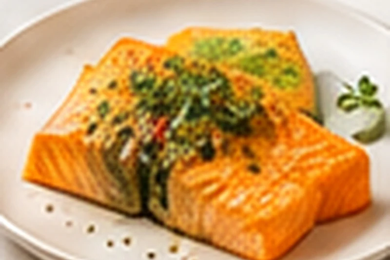 A baked salmon fillet with sweet potato pieces and zucchini on a light plate, scattered with dill.